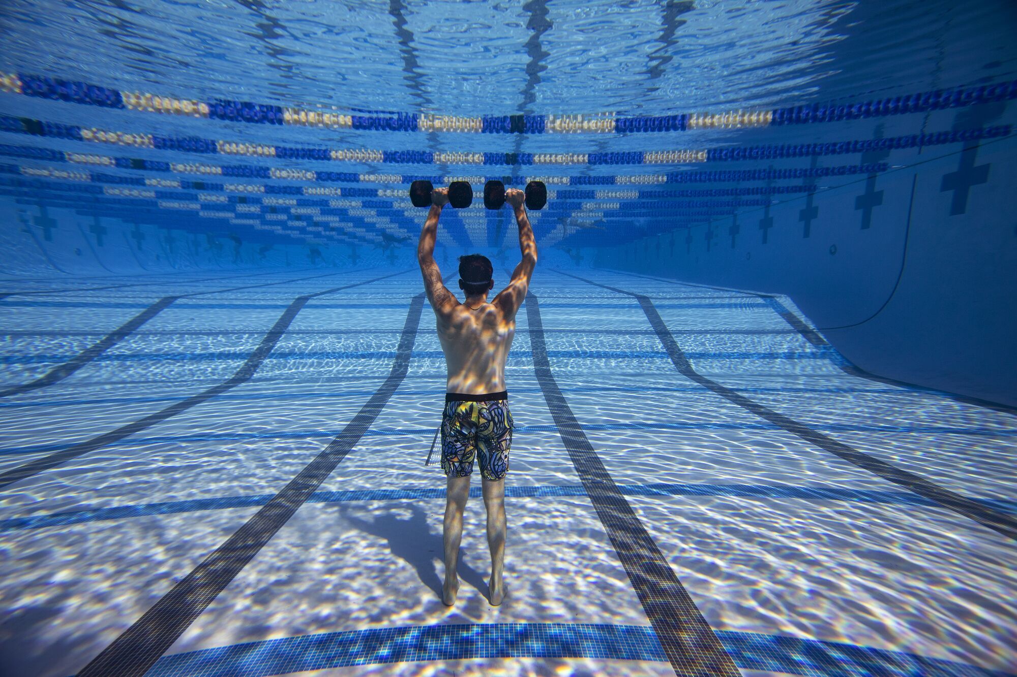 Padres pitcher Joe Musgrove lifts with 40-pound weights in the bottom of pool in January.