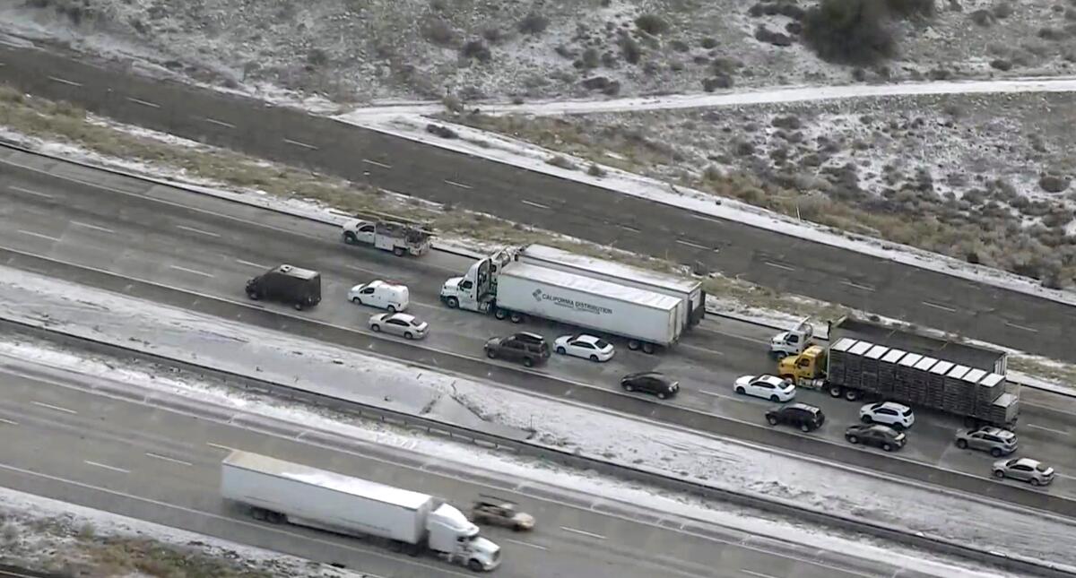 Snow is visible on the edges of the 5 Freeway