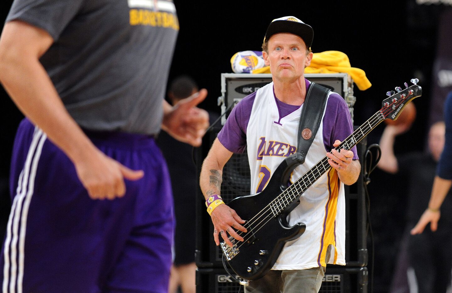Rock star "Flea" rehearses the national anthem before Kobe Bryant's last game on April 13, 2016, as players warm-up.