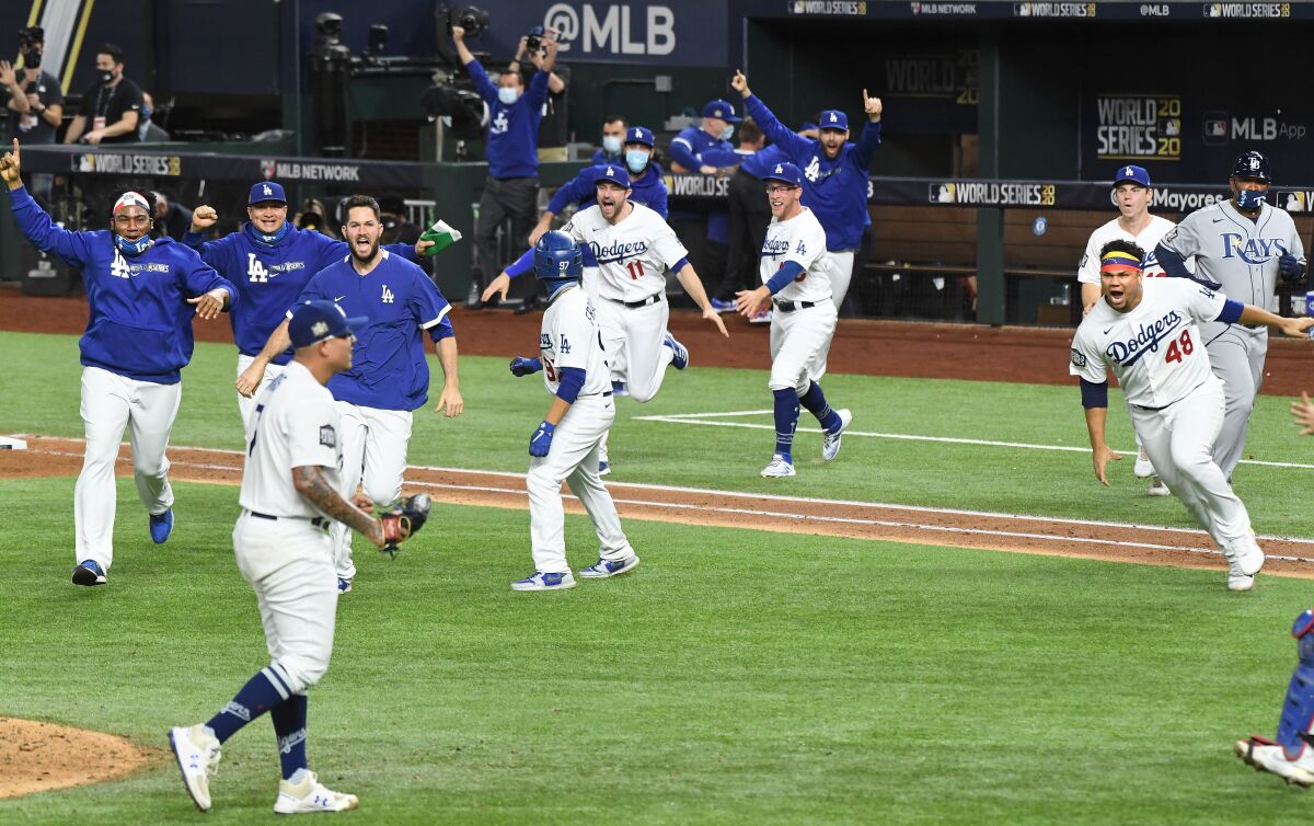 Dodgers players storm the field after pitcher Julio Urías records the final out of Game 6 in the 2020 World Series.