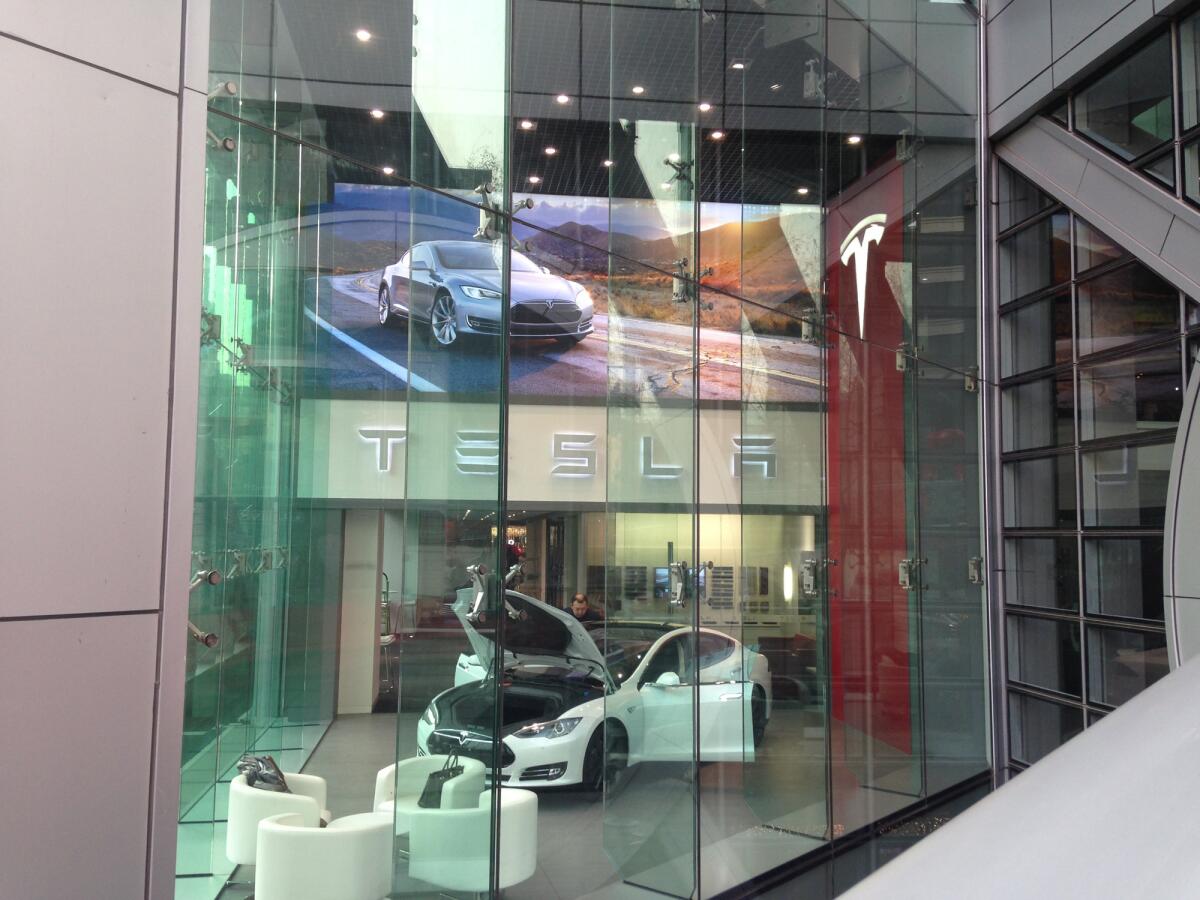 Are the Teslas being shipped to China not winding up in consumer's hands? An analyst believes they're being ordered at showrooms, like this one in a Beijing shopping center, but are actually being bought by speculators or "scalpers."