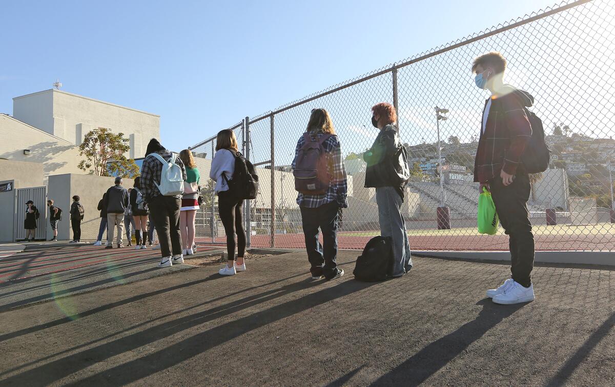 Students arrive for in-person instruction at Laguna Beach High on Wednesday after the school closed one year ago.