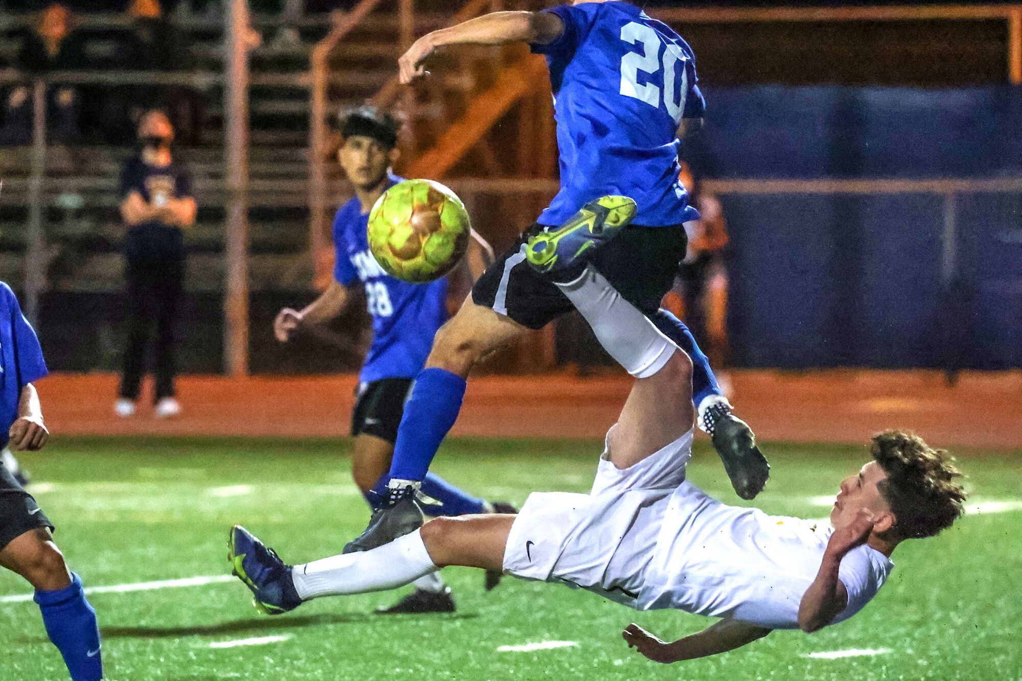Birmingham's Joseph Barcenas attempts a scissor kick as El Camino Real's Eric Cabadas defends.