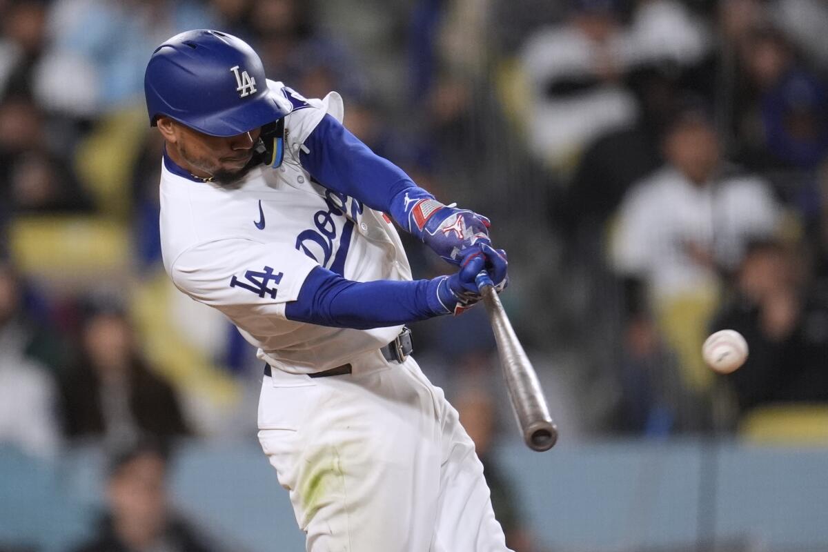 Dodgers shortstop Mookie Betts connects for a single against the Padres in the third inning Saturday.