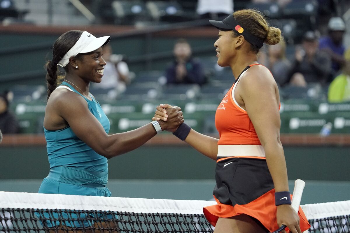 Naomi Osaka, of Japan, right, shakes hands with Sloane Stephens after defeating her at the BNP Paribas Open tennis tournament Thursday, March 10, 2022, in Indian Wells, Calif. (AP Photo/Mark J. Terrill)