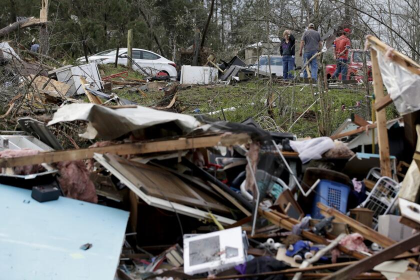 Residents begin the clean up process after a tornado touched down damaging multiple homes Friday, March 26, 2021 in Wellington, Ala. A tornado outbreak has ripped across the Deep South leaving paths of destruction. (AP Photo/Butch Dill)