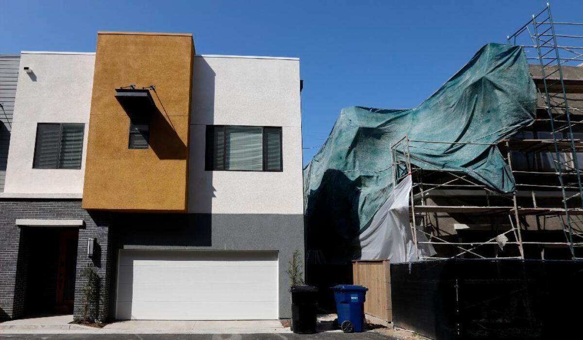 A town home development being built in Bellflower by City Ventures, with all-electric, solar-powered homes, on March 25, 2019. Some of the homes are still under construction; others are finished.