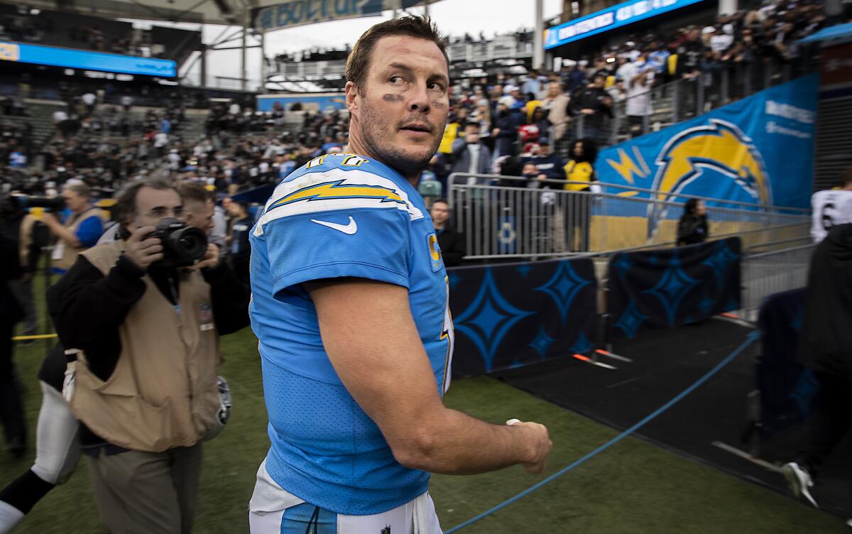 Chargers quarterback Philip Rivers looks back toward the field as he walks off following a 24-17 loss to the Oakland Raiders at Dignity Health Sports Park on Sunday.