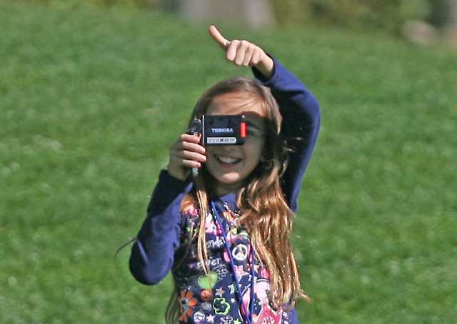 Maria Jesus Rosas, 9, gives her father Ignacio a thumbs-up while filming him at the Toshiba Classic Pro-Am at Newport Beach Country Club on Wednesday.