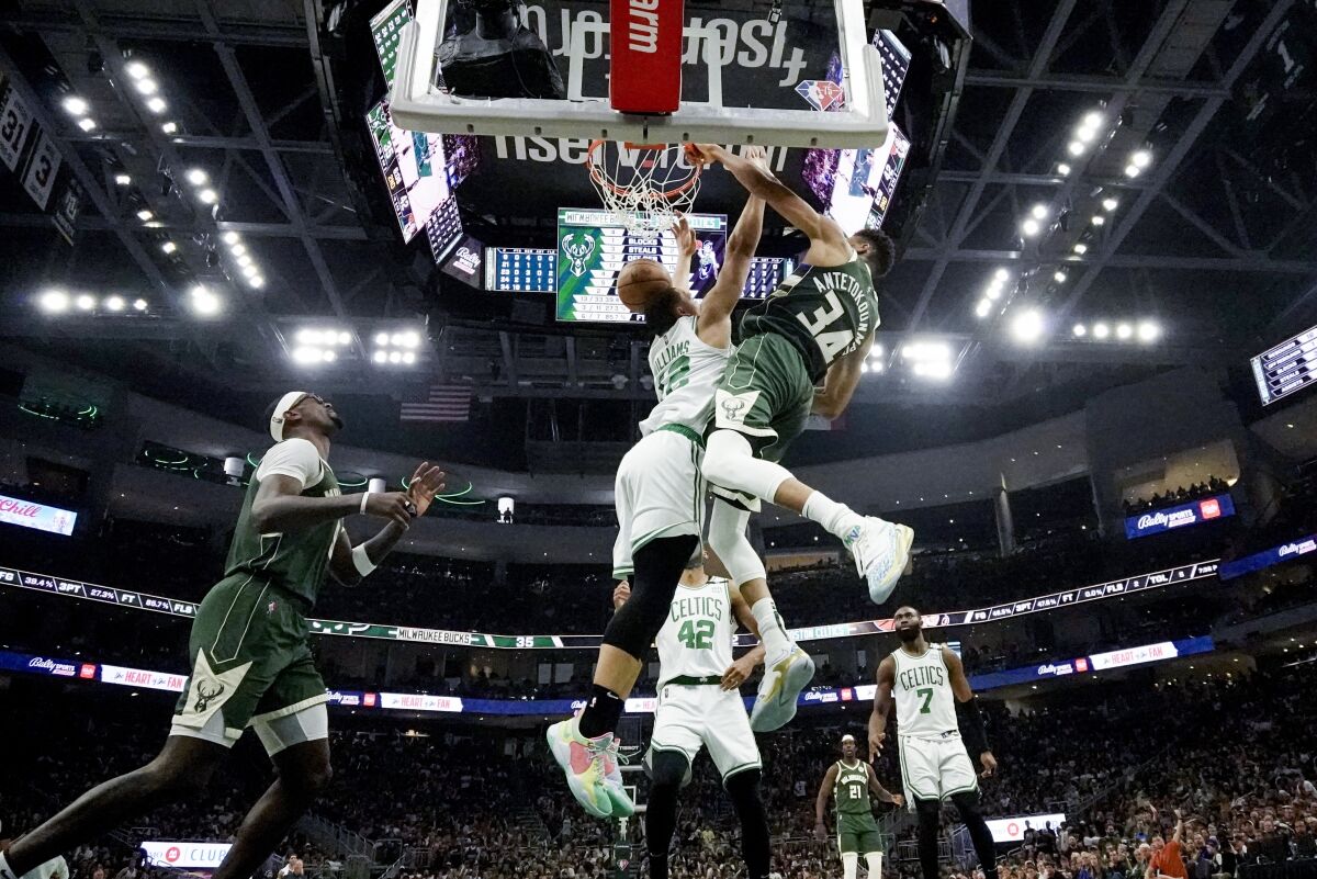 The Bucks' Giannis Antetokounmpo dunks over the Celtics' Grant Williams on May 13, 2022.