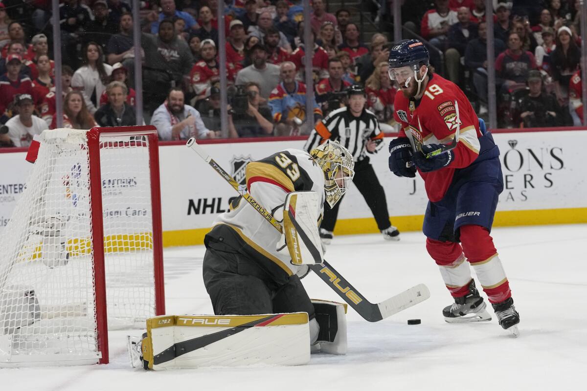 Vegas Golden Knights goaltender Adin Hill goes after a shot on goal by Florida Panthers left wing Matthew Tkachuk.