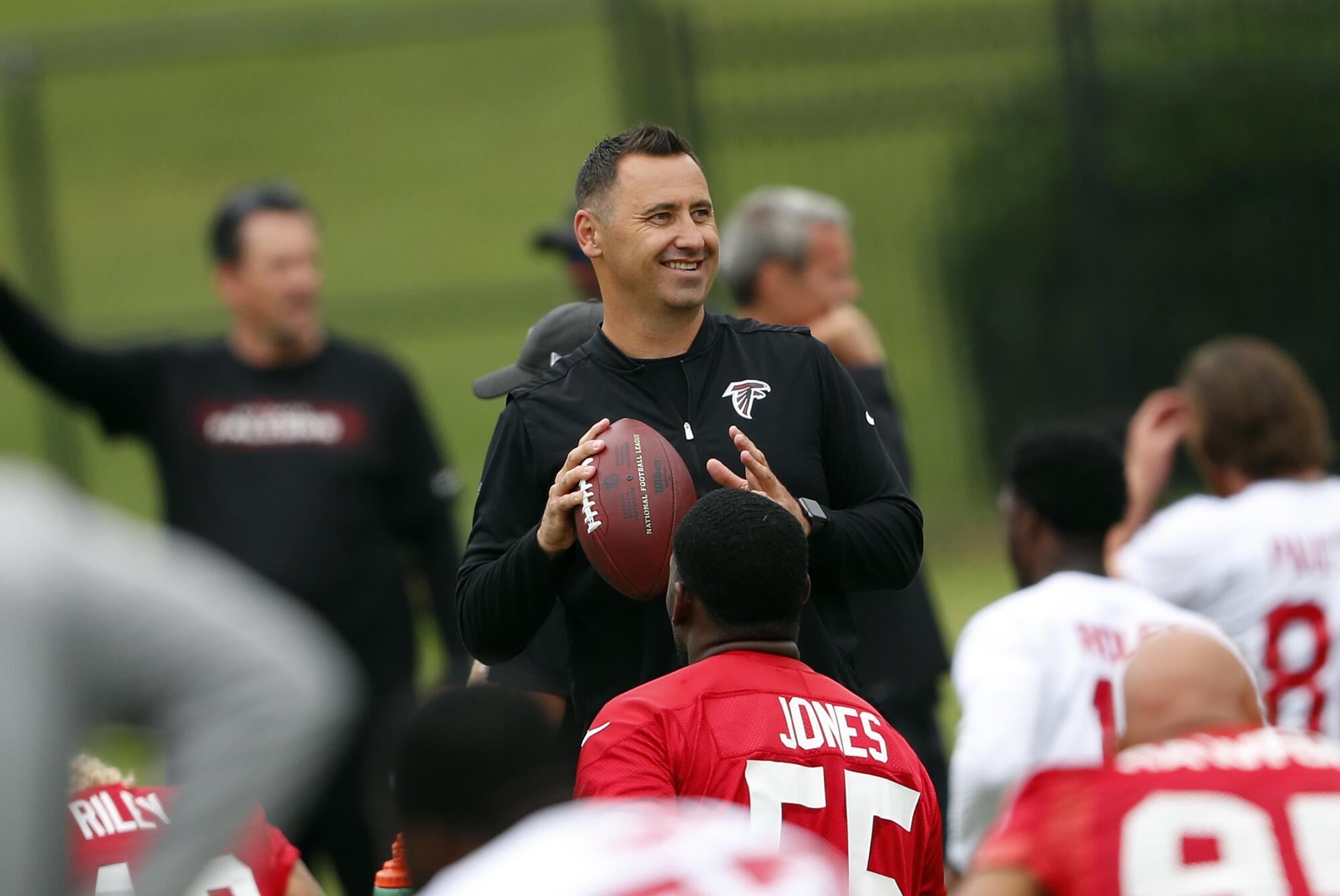 Atlanta Falcons offensive coordinator Steve Sarkisian grips a football during practice in 2018. 