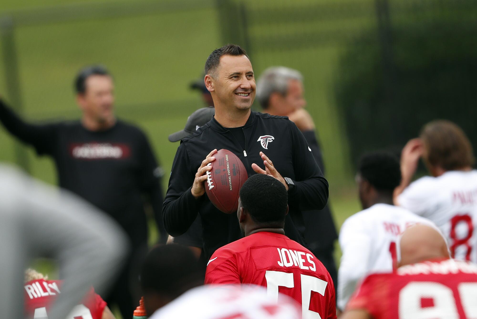 Atlanta Falcons offensive coordinator Steve Sarkisian grips a football during practice in 2018.