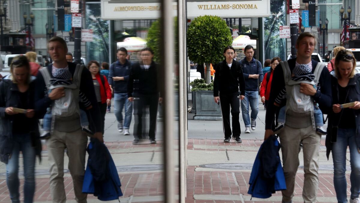 Pedestrians walk along Post Street in San Francisco. The city became the first in the United States to ban facial recognition technology by police and city agencies.