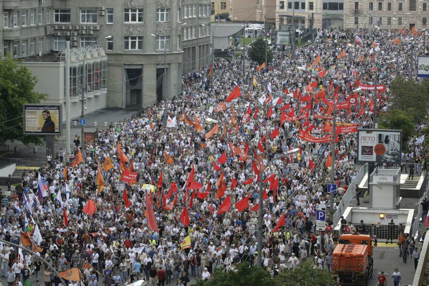 Demonstrators hold the flags of various groups during a massive protest on Tuesday in Moscow against Russian President Vladimir Putin's rule.