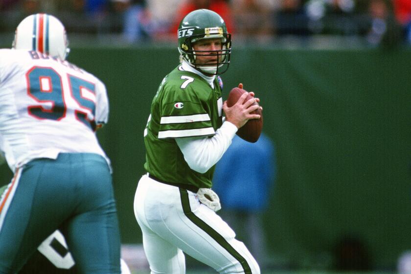 EAST RUTHERFORD, NJ - NOVEMBER 27: Boomer Esiason #7 of the New York Jets drops back to pass against the Miami Dolphins during an NFL football game at the Meadowlands November 27, 1994 in East Rutherford, New Jersey. Esiason played for the Jets from 1993-95. (Photo by Focus on Sport/Getty Images)