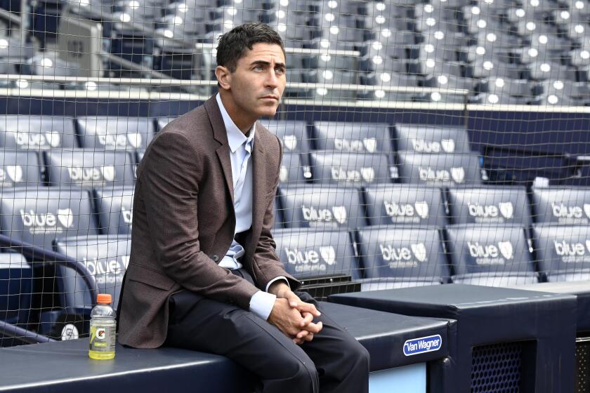 San Diego Padres general manager A. J. Preller watches his team warm up before a baseball game against the Colorado Rockies in San Diego, Thursday, March 30, 2023. (AP Photo/Alex Gallardo)