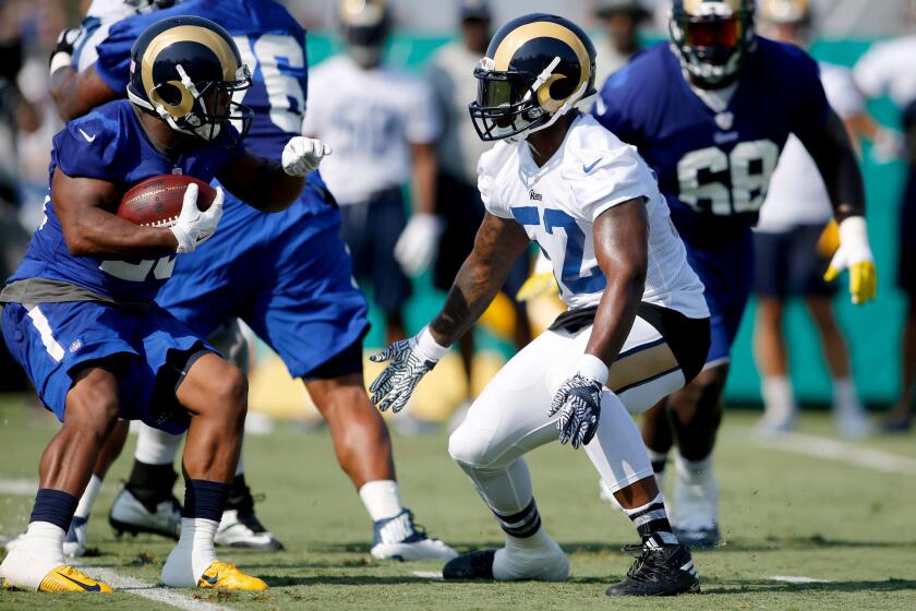 The Rams' Alec Ogletree, in white jersey, takes part in training camp at UC Irvine. Ogletree is switching to middle linebacker.
