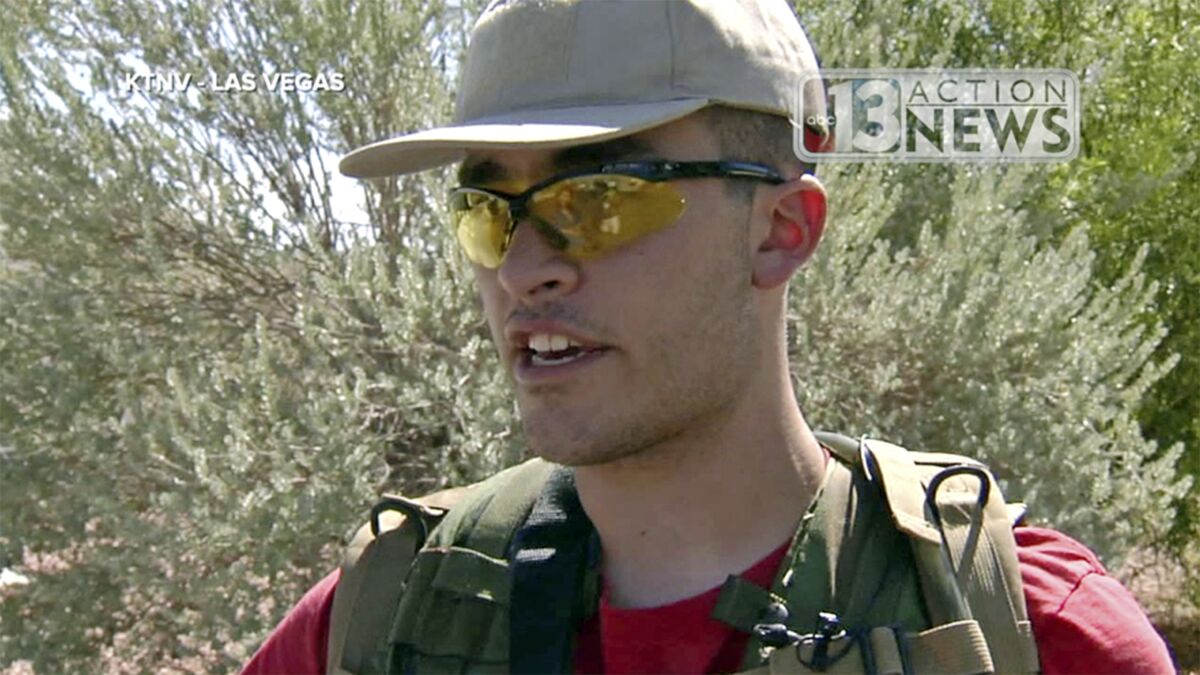 This Sept. 22, 2016 file photo from video from KTNV 13 Action News shows Conor Climo during an interview while walking a Las Vegas neighborhood, heavily armed. Climo, accused of assembling materials to bomb and shoot people at a synagogue, a bar catering to LGBTQ customers or a fast-food restaurant was indicted on a federal firearm charge.
