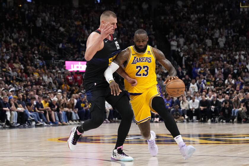 Los Angeles Lakers forward LeBron James (23) drives past Denver Nuggets center Nikola Jokic, left, during the second half in Game 2 of an NBA basketball first-round playoff series Monday, April 22, 2024, in Denver. (AP Photo/Jack Dempsey)