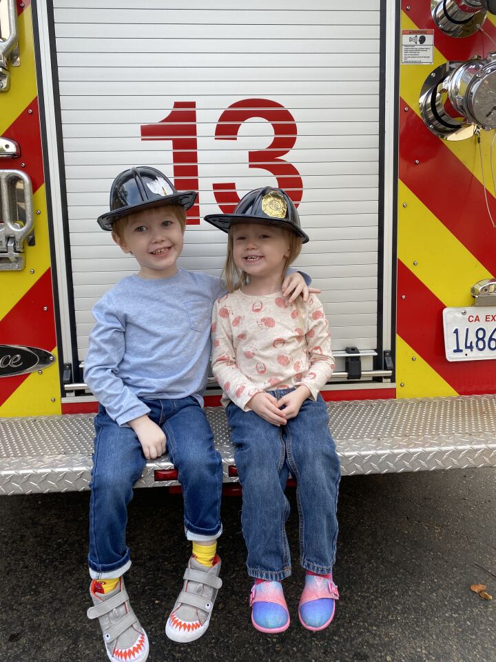 Alex and Reese Mackenzie pose on the back of a Fire Station 13 rig at the La Jolla/Riford Library on Nov. 4.