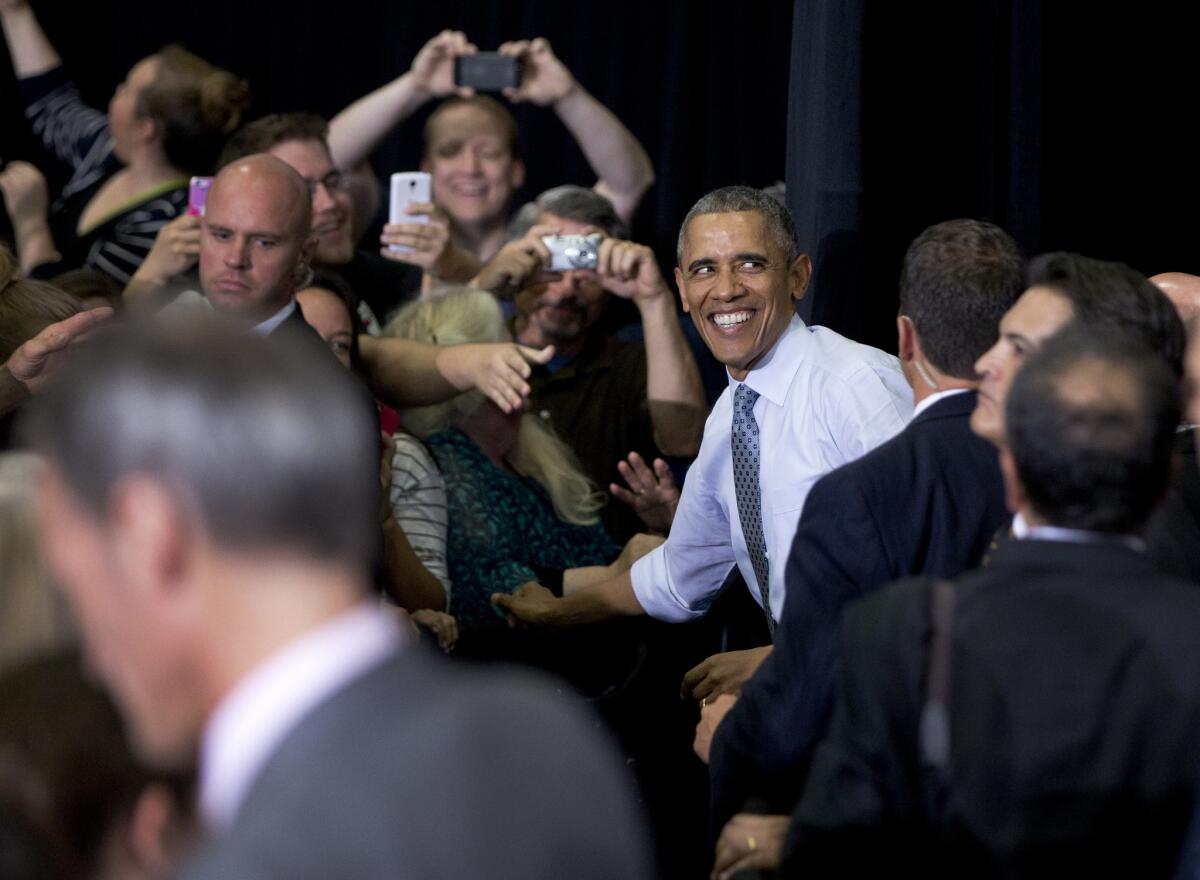 President Obama greets audience members after giving a speech about the economy and a proposed Labor Department rule that would make more workers eligible for overtime in Wisconsin last July.