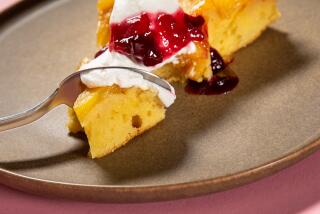 EL SEGUNDO, CA - THURSDAY, MAY 25, 2023 - A slice of a Pineapple Upside Down Cake toped with whipped cream and cherry compote, photographed in the LAT Test Kitchen. The batter is spread over the pineapple in the baking tray. (Ricardo DeAratanha/Los Angeles Times)