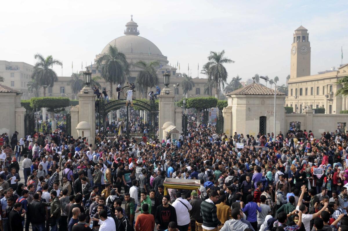 Student protesters gather outside the main gate of Cairo University in Cairo on Sunday. Several hundred students and supporters of the country's ousted Islamist president joined to protest the death of Mohammed Reda, a student who was killed in clashes Thursday near the university.