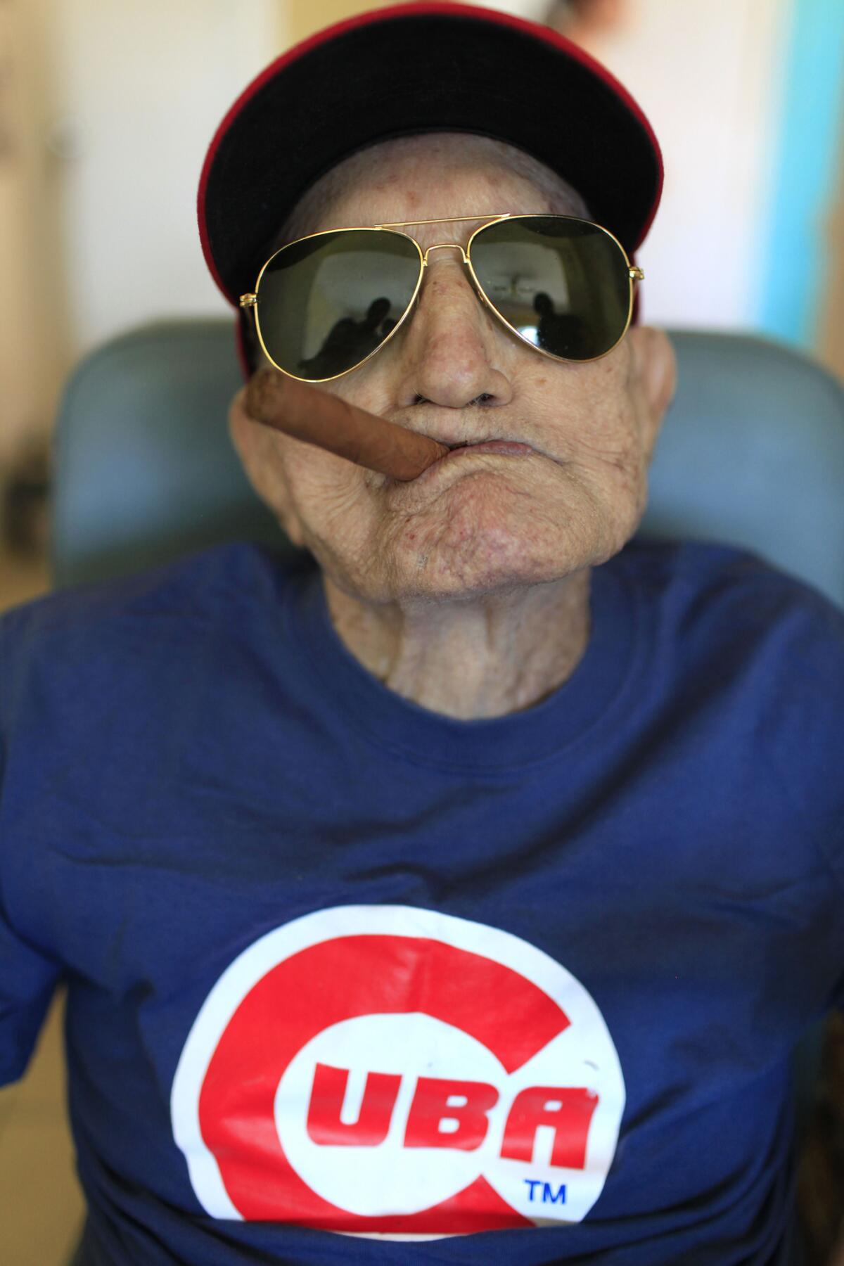 Conrado Marrero, the world's oldest living former Major League Baseball player, poses for a photo on his 102 birthday at his home in Havana, Cuba, on April 25, 2013.