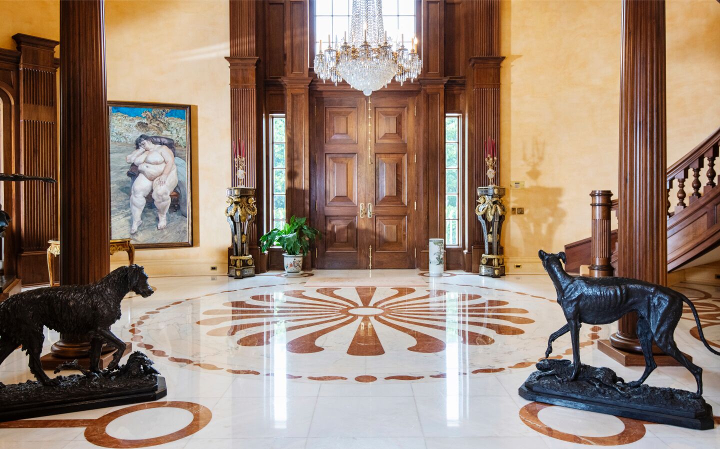 An elaborate chandelier, sculptures of dogs and a classical portrait of a nude woman adorn the foyer.