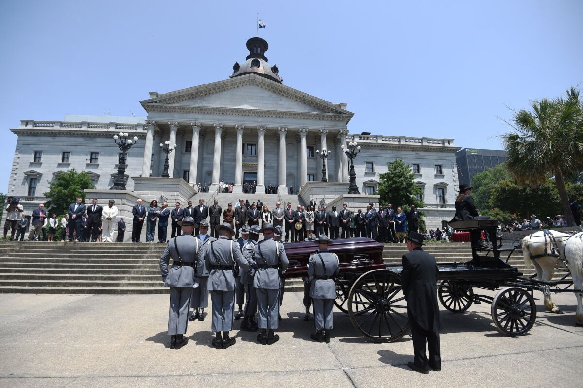 A South Carolina Highway Patrol honor guard carries the casket of Sen. Clementa Pinckney to the Statehouse on June 24 in Columbia, S.C.