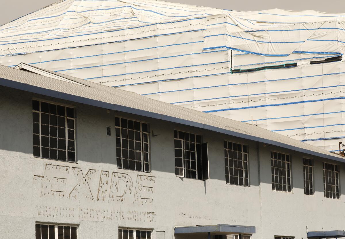 Portions of the closed Exide lead-acid battery recycling plant wrapped in white plastic. 