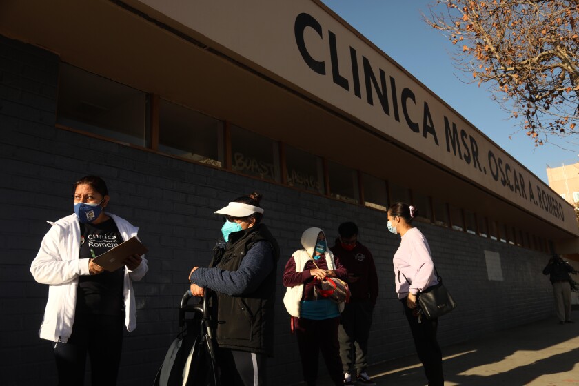 People wait in line to be vaccinated outside a clinic