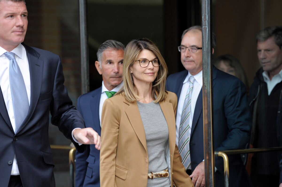 Actress Lori Loughlin exits the courthouse after facing charges for allegedly conspiring to commit mail fraud and other charges in the college admissions scandal at the John Joseph Moakley United States Courthouse in Boston.