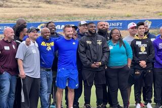 Rams coach Sean McVay poses with more than 60 high school football coaches at Rams training camp 