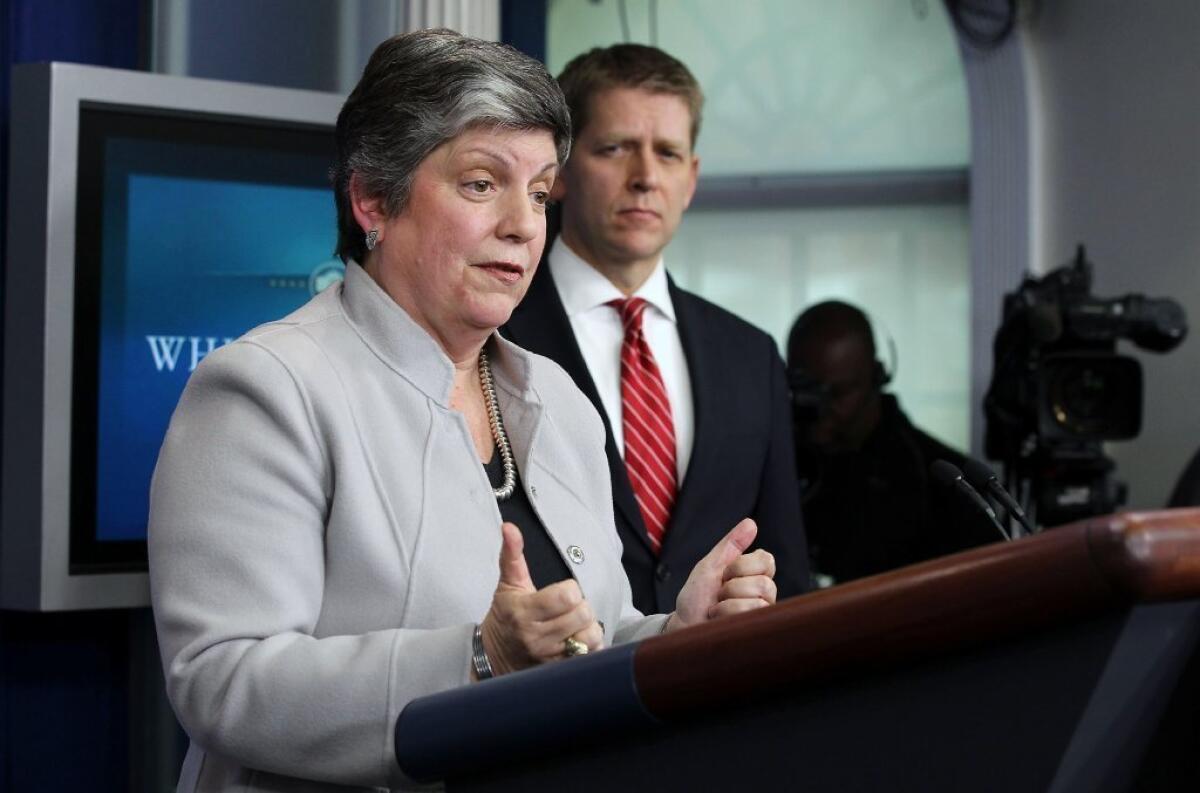 Homeland Security Secretary Janet Napolitano speaks Monday at the White House about the effect of looming spending cuts as White House Press Secretary Jay Carney looks on.