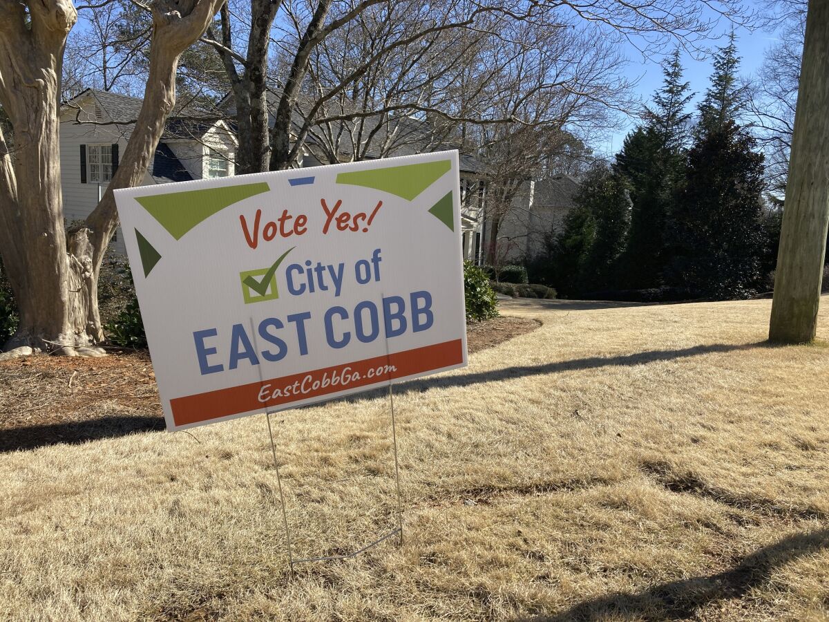 A sign in the ground outside a home in Cobb County on Feb. 14, 2022 encourages residents to vote in favor of creating the city of East Cobb. It's one of three cityhood referendums coming up in May in Cobb County that follow the election of three Black women to the county commission in the 2020 election, giving Democrats a majority on the commission for the first time in decades. (AP Photo/Sudhin S. Thanawala)