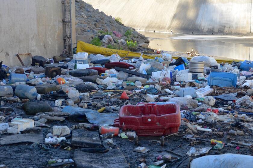 The Santa Ana Delhi River Channel waterway is cluttered with debris in less than a month after cleanup.