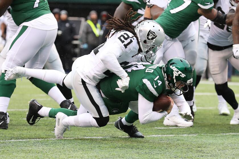Jets quarterback Sam Darnold gets past Raiders defensive back D.J. Swearinger to score a touchdown during their game Nov. 24, 2019, in East Rutherford, N.J..