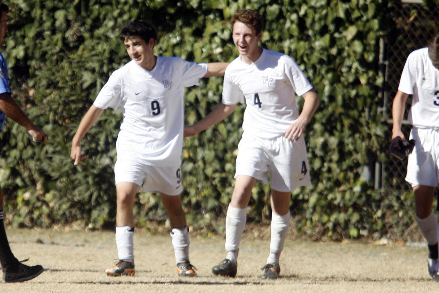 Flintridge Prep's Ari Baraian, left, and Daniel Enzminger hug each other after their team makes a point during a game against Pasadena at Flintridge Prep in La Canada on Saturday, January 19 2013.