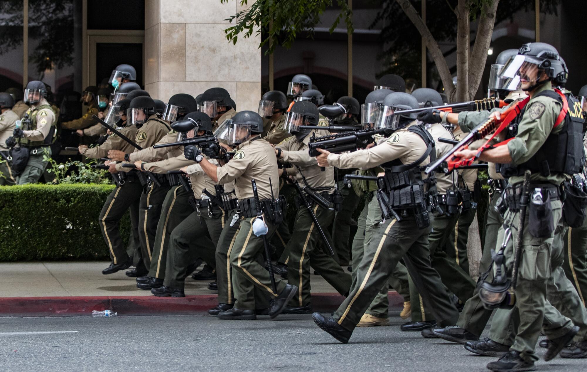 Riverside County sheriffs advance on demonstrators who refused to disperse after the 6 p.m. curfew.