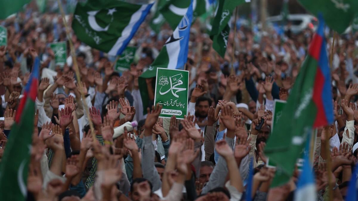Supporters of Islamic political party Jamat-e-Islami in Karachi hold placards on Nov. 4, 2018, bearing the name of the prophet Muhammad during a protest after the Supreme Court in Pakistan acquitted Asia Bibi, a Christian accused of blasphemy.