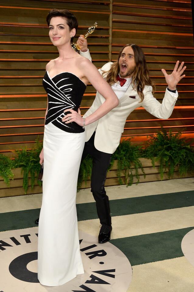 Actors Anne Hathaway and Jared Leto display both the spirit and glitz of the 2014 Vanity Fair Oscars party hosted by Graydon Carter in West Hollywood, Calif.