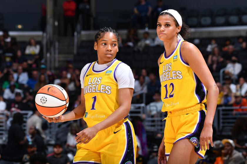 Zia Cooke dribbles and Rae Burrell looks up court during the Sparks' lopsided loss to the Liberty