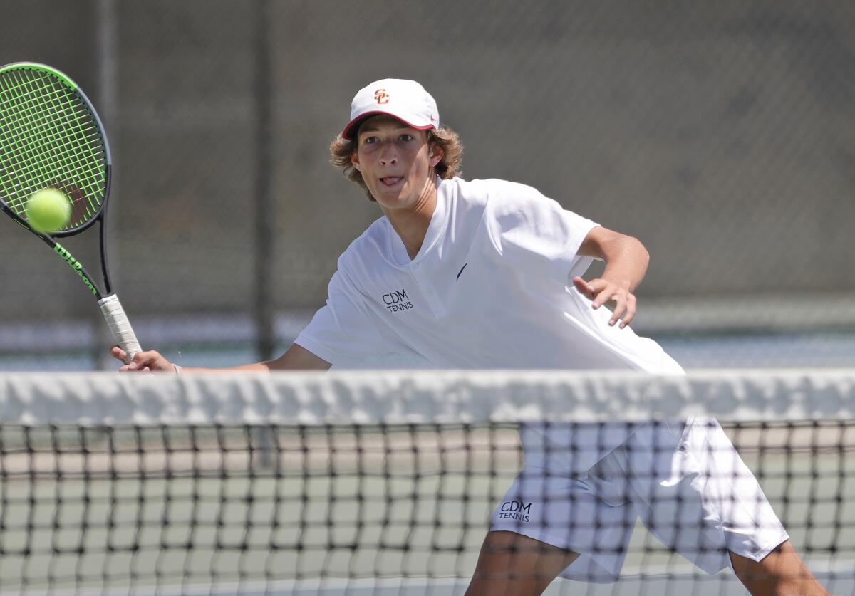 Niels Hoffmann of Corona del Mar steps into a volley for a point at the net with doubles partner Jack Cross on Thursday.