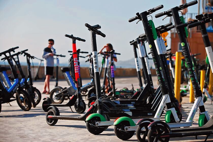 An electric scooter hub is seen on the Mission Beach boardwalk with scooters from various companies. San Diego City Council voted Dec. 16, 2019 to ban e-scooters and other motorized devices on the boardwalks from La Jolla to Mission Beach.