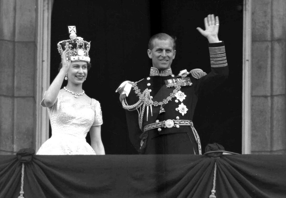 Britain's Queen Elizabeth II and Prince Philip, Duke of Edinburgh, as they wave to supporters from the balcony at Buckingham Palace, following her coronation at Westminster Abbey. London. This is a June. 2, 1953 file photo