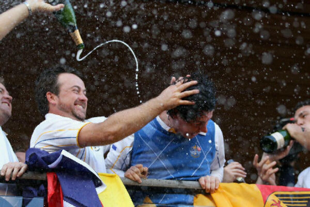 Graeme McDowell rubs champagne into the hair of Rory McIlroy after Europe's win in the 2010 Ryder Cup.