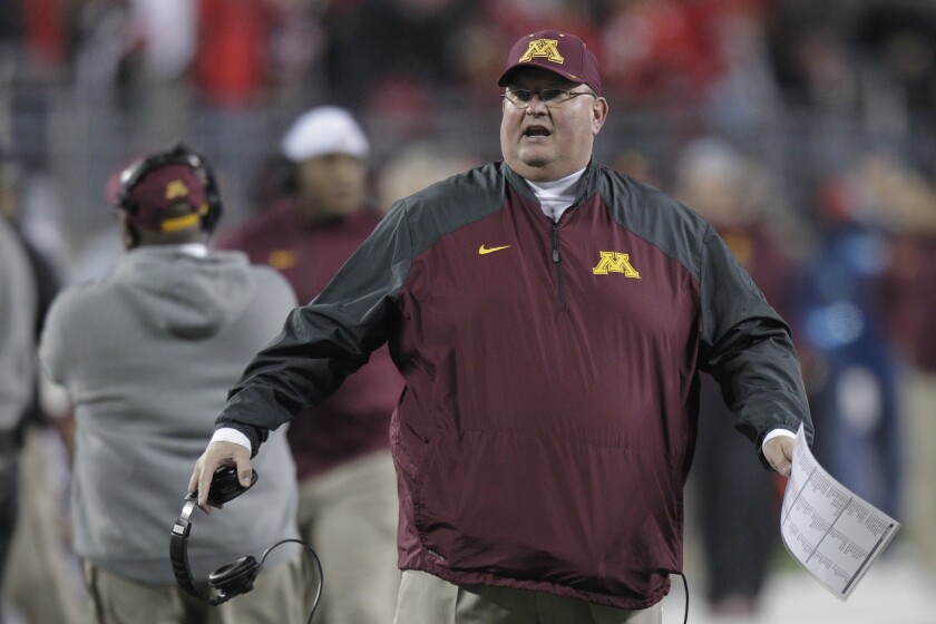 Minnesota coach Tracy Claeys walks on the sideline during a game.