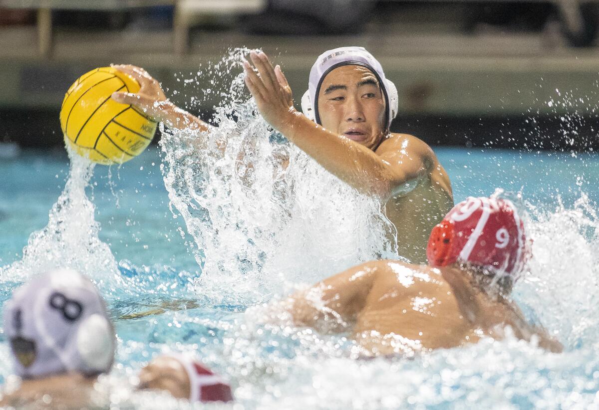 Huntington Beach's Garrett Lee takes a shot against Orange Lutheran's Miles Wilson in the first round of the CIF Southern Section Division 1 playoffs at Santiago Canyon College in Orange on Thursday.